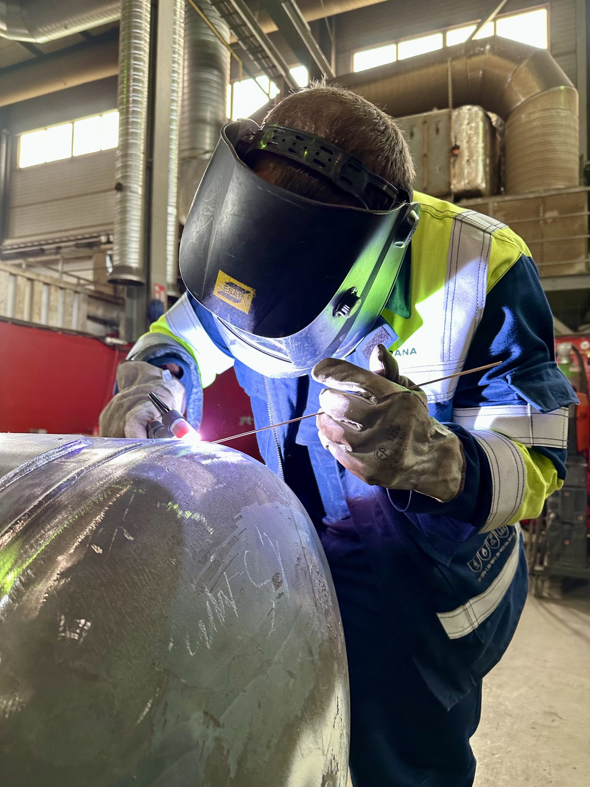 Mechanical Contractor — welder fabricating a pressure vessel in workshop.