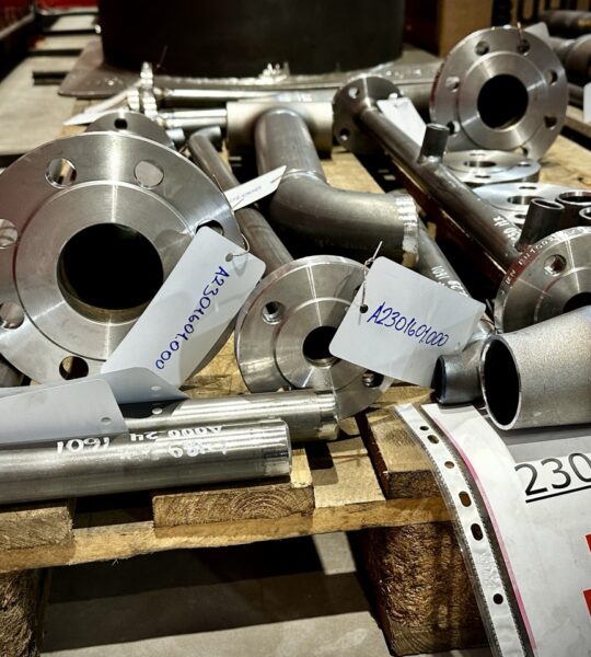 Prefabricated pipe spools with indicator marking prepared by a piping installation company for industrial construction