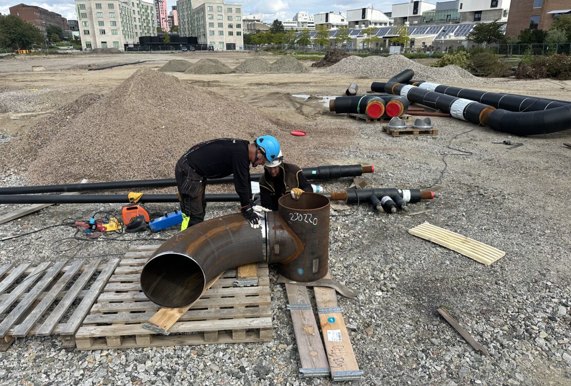 Piping installation – worker installing tee with branch connection in industrial piping system