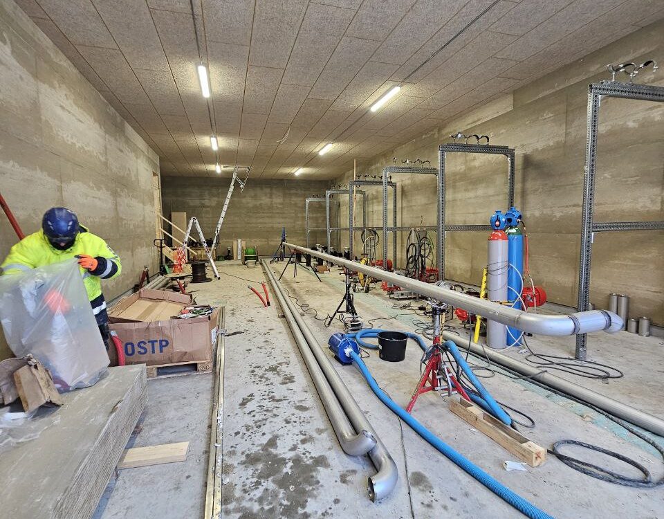 Biogas plant installation – pump station room with industrial piping and equipment